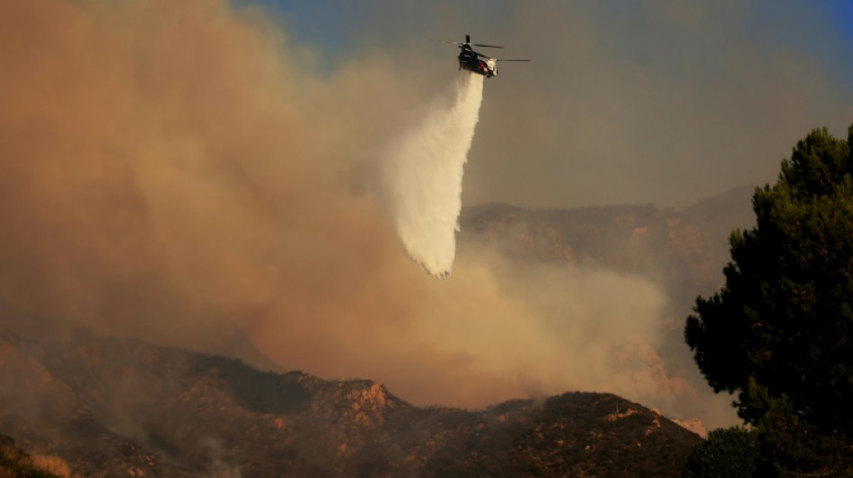 Thousands told to flee as wildfire tears through Malibu