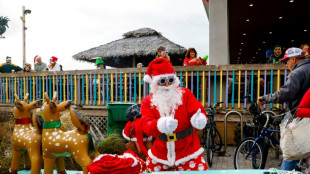 Surfing Santas ride waves, raise funds in Florida