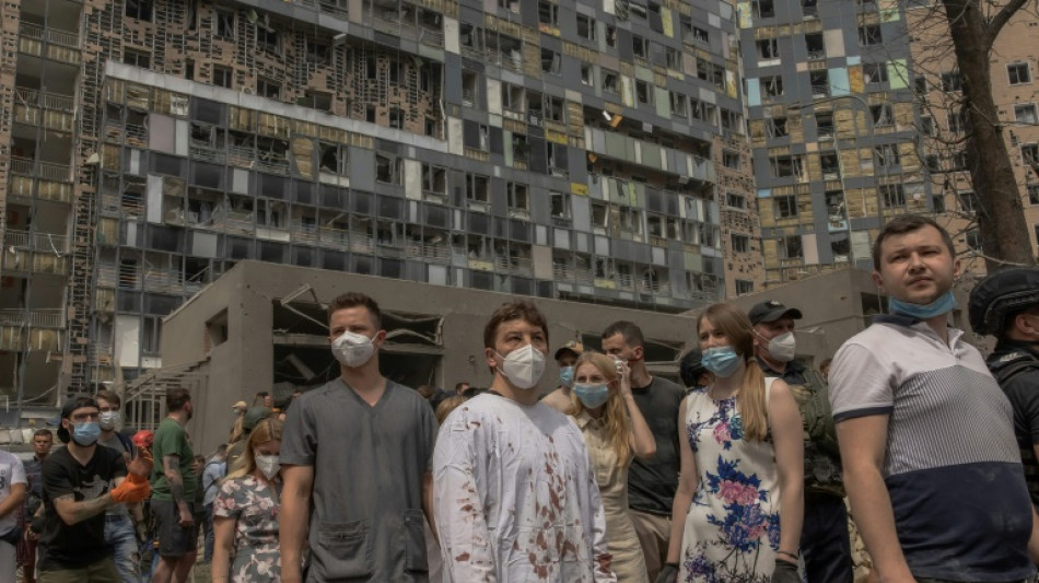 Mourning in Kyiv as rescuers clear rubble from children's hospital