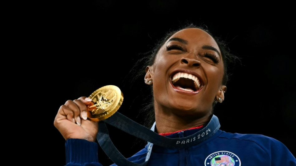 Beaming Biles bags Olympic gymnastics triple, as women's 100m looms