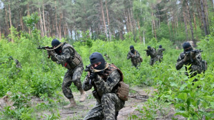 Ukrainians train with army in Bucha base abandoned by Russia