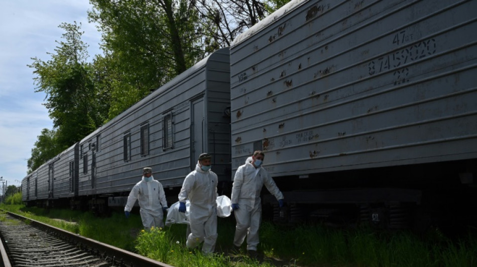 Ukrainian forces collect Russian dead left behind