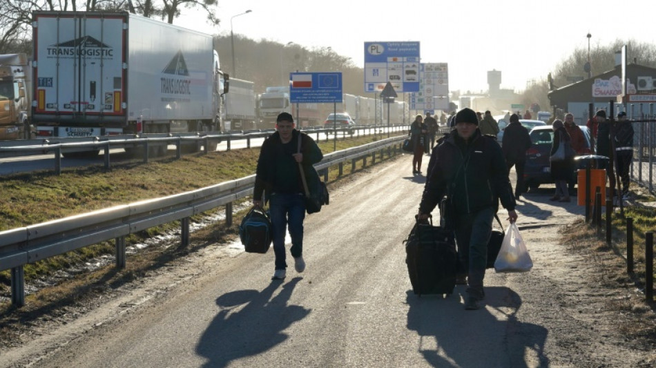 Ukrainian refugees camp out at Polish train station  