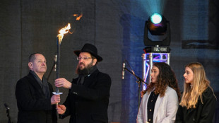 Scholz first German leader to light main Hanukkah menorah