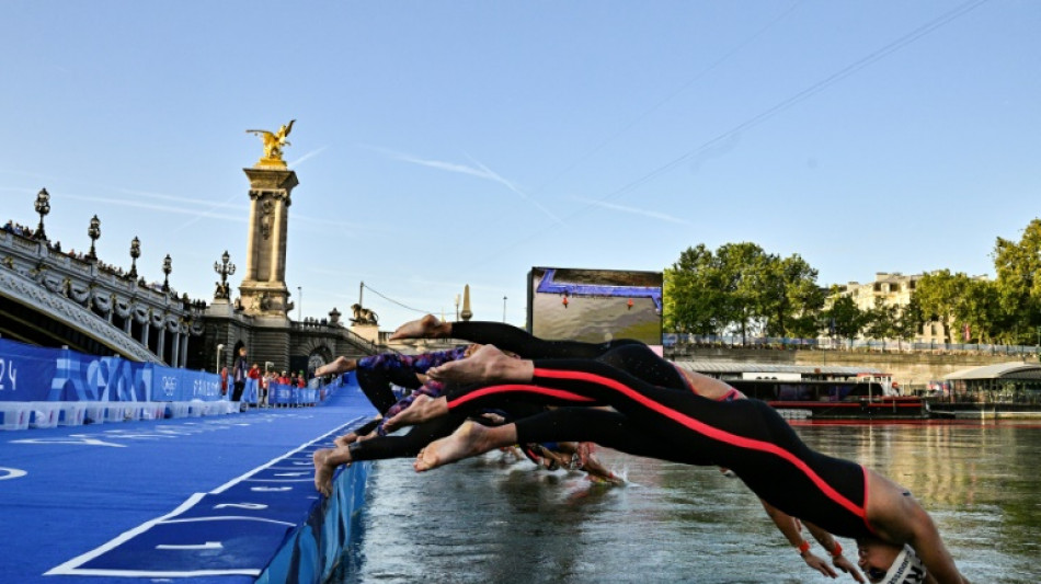 Olympic swimmers plunge into Seine, Lyles eyes sprint double